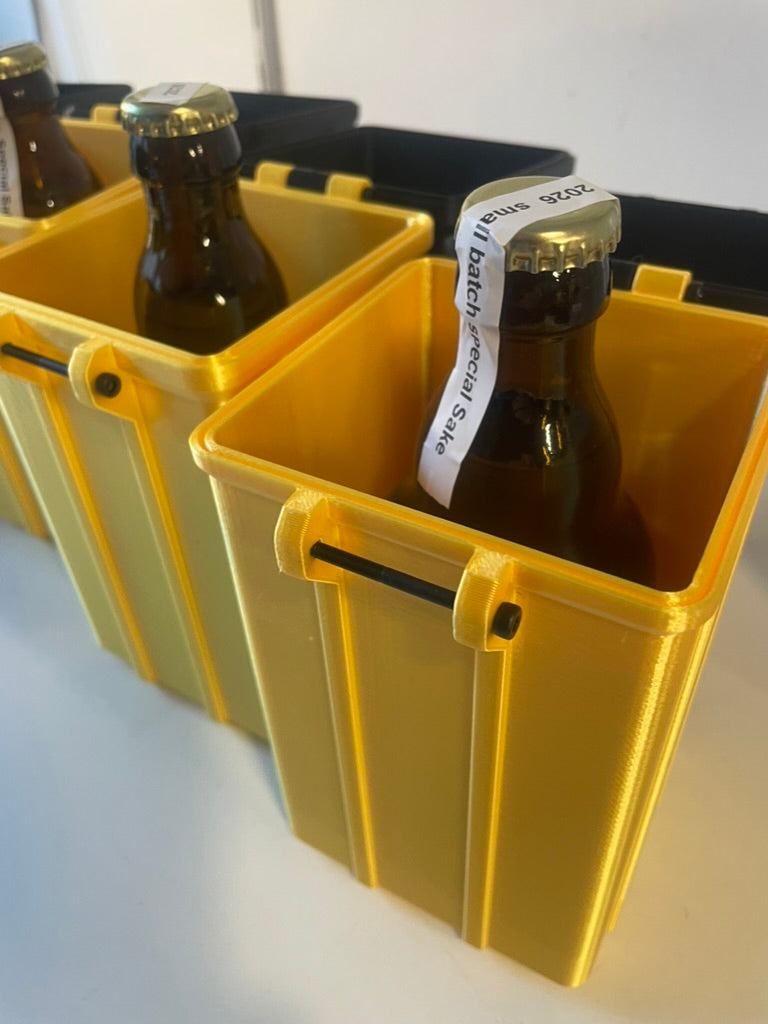 Gold giftboxes with sake bottles inside on a white background