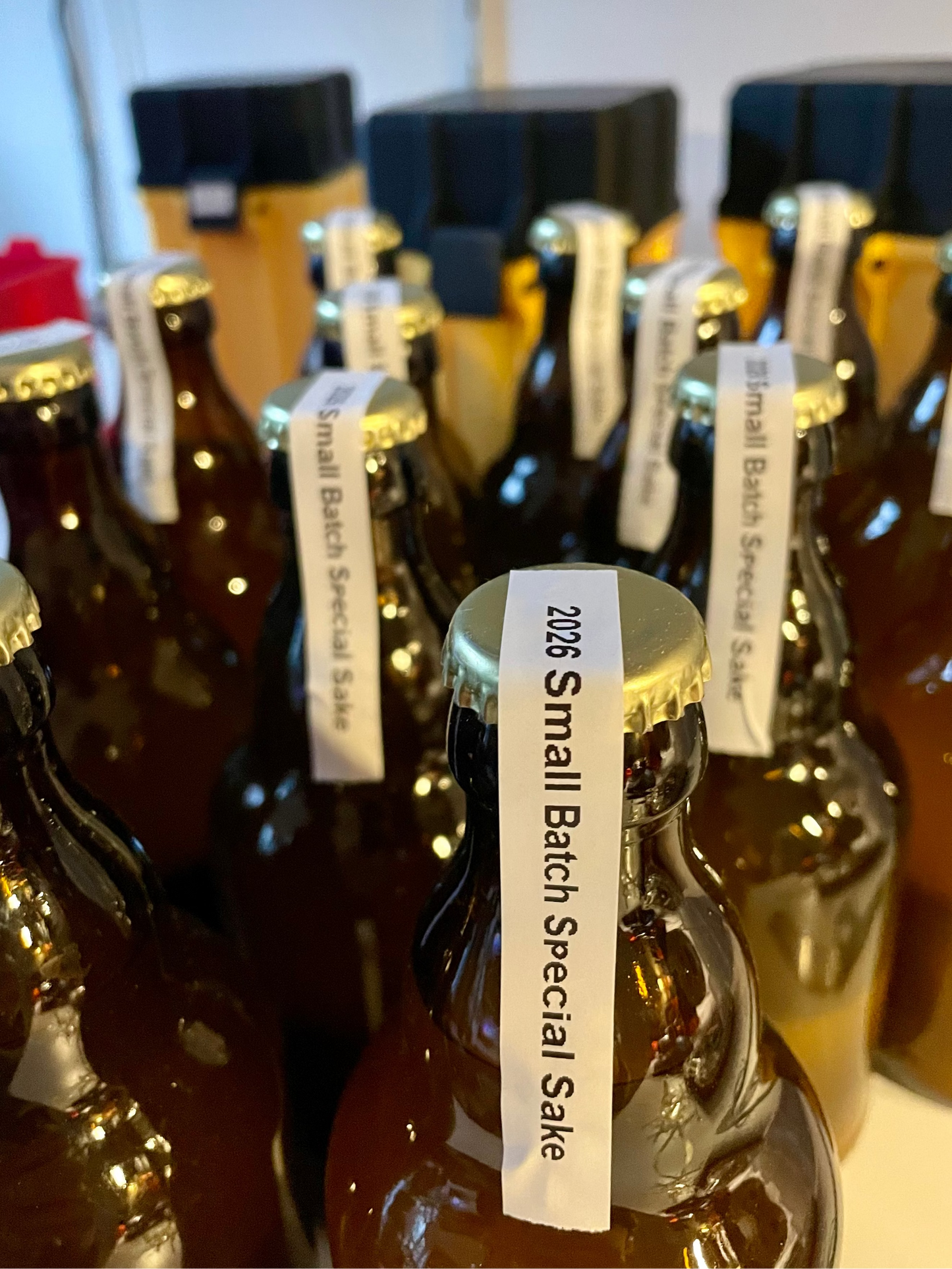 Bottles of 2026 Small Batch Special Sake with labels on a white background