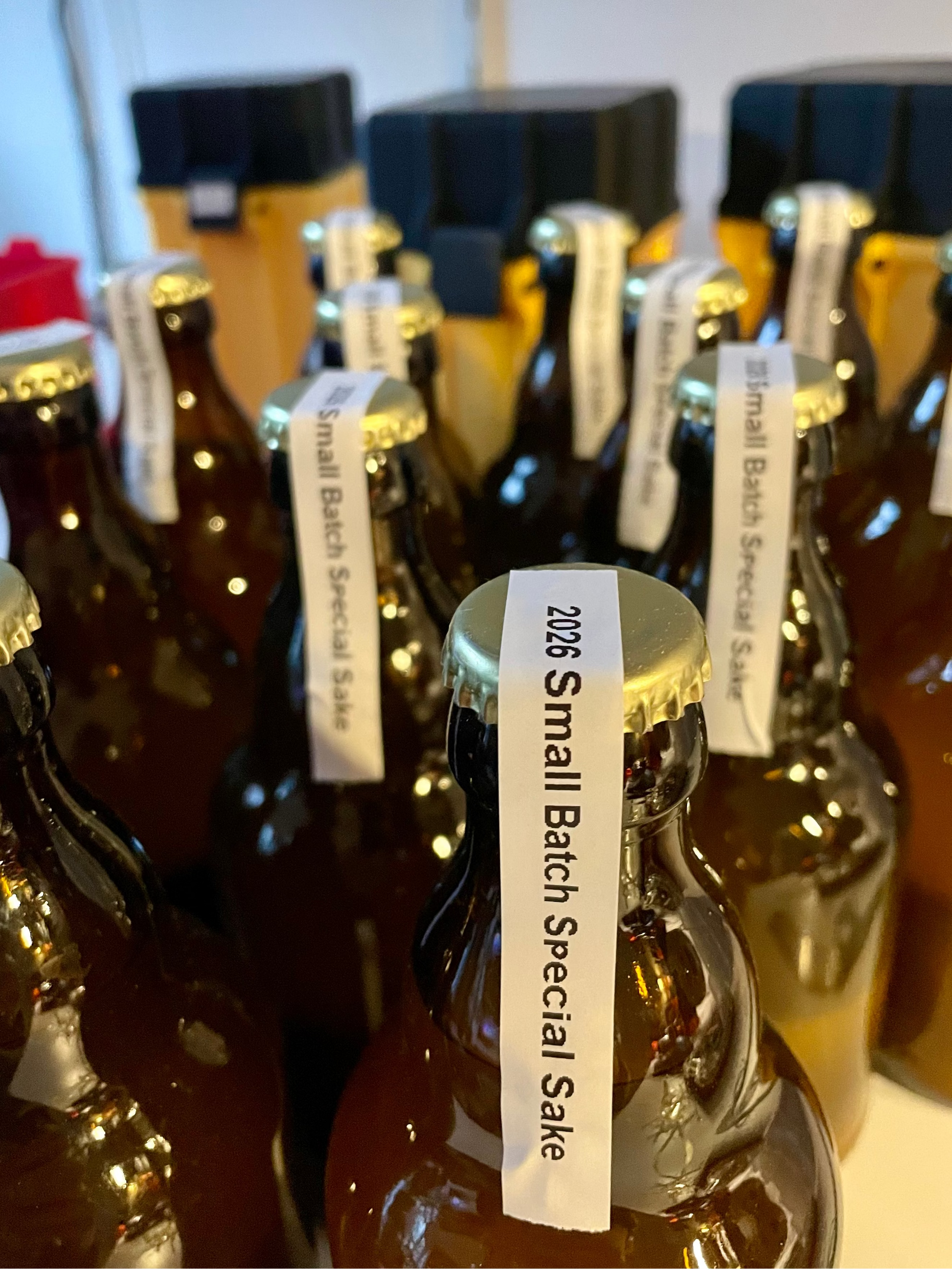 Bottles of 2026 Small Batch Special Sake with labels on a white background