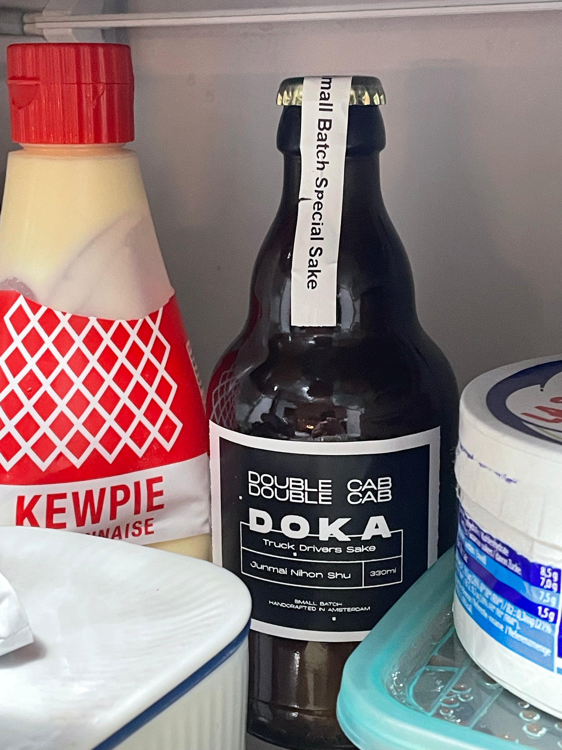 Bottle of Double Cab Special Doka sake in a refrigerator.